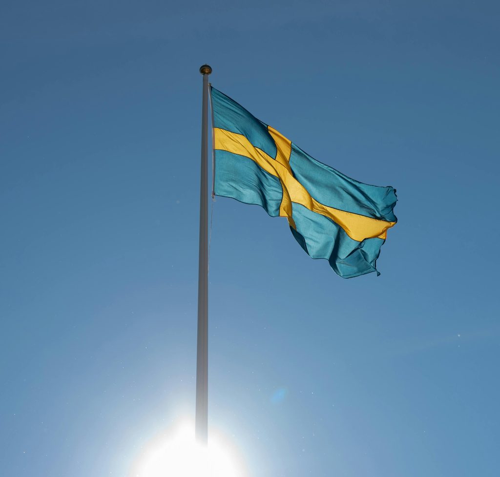 Swedish flag on pole during sunny day